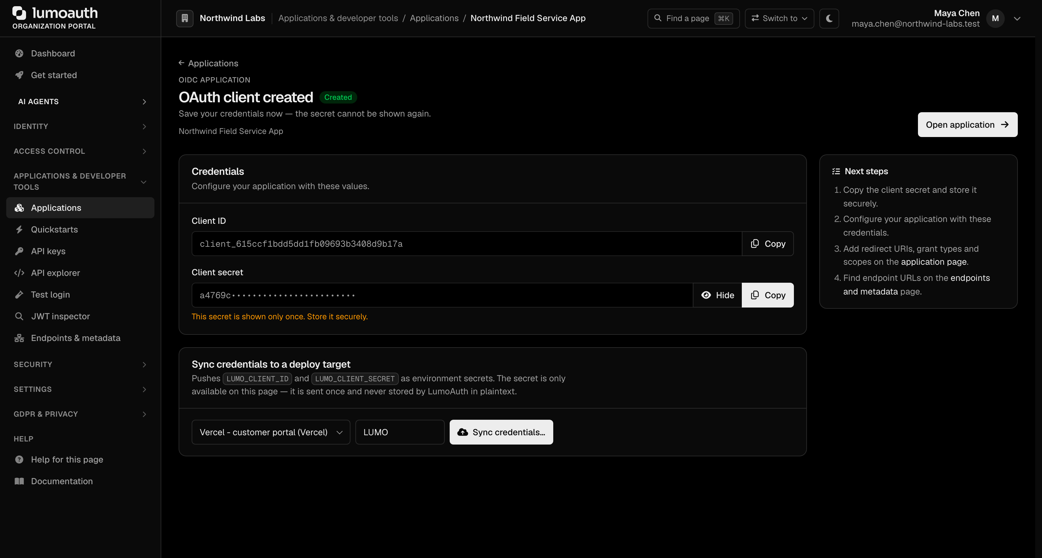 The OAuth client created page showing the client ID, the masked one-time client secret and the sync-to-deploy-target card